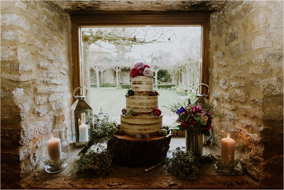 Wedding cake with floral decor at barn wedding venue