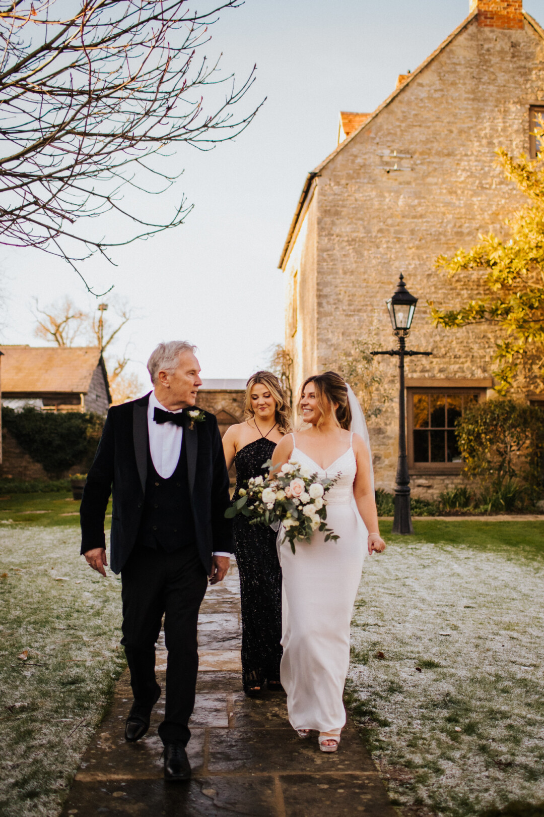 Walking through the farmhouse gardens to the wedding ceremony.
