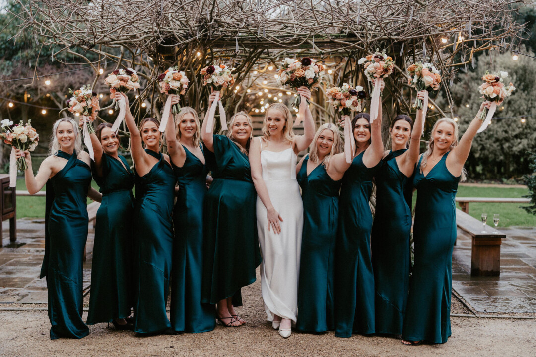 Winter bride and her bridesmaids by the wedding aisle