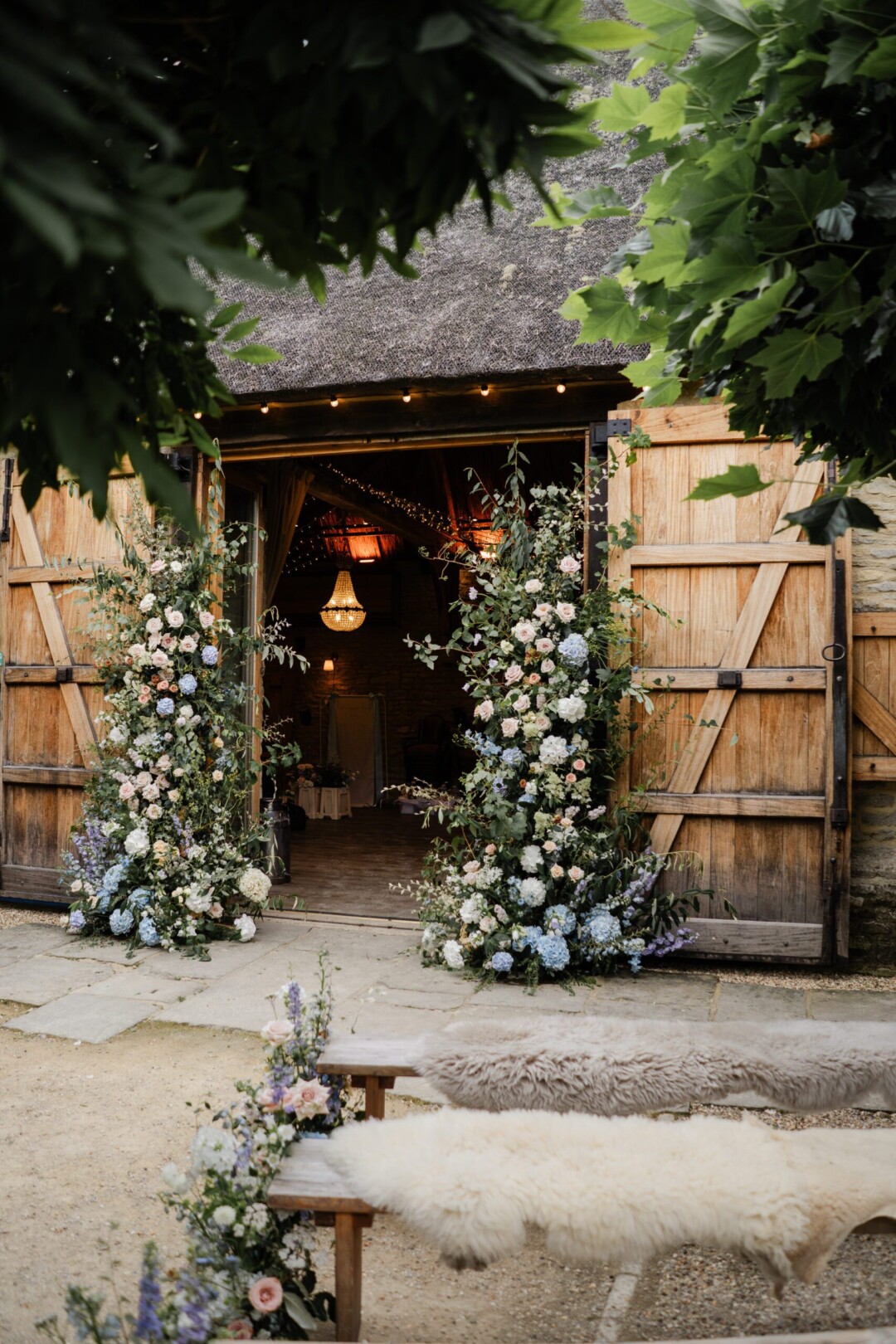 Barn doors derated with floral arch for summer wedding